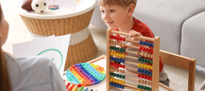 little boy playing abacus psychologists office